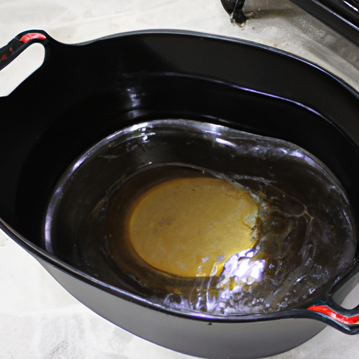 A Dutch oven being seasoned with a thin layer of cooking oil.